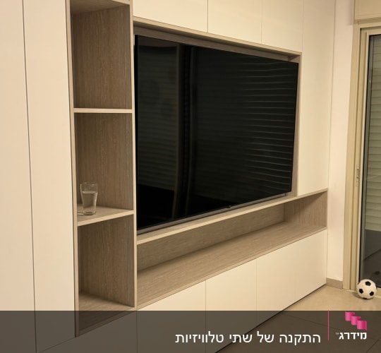 ארון עץ עם מדפים וטלוויזיה, כדור על הרצפה